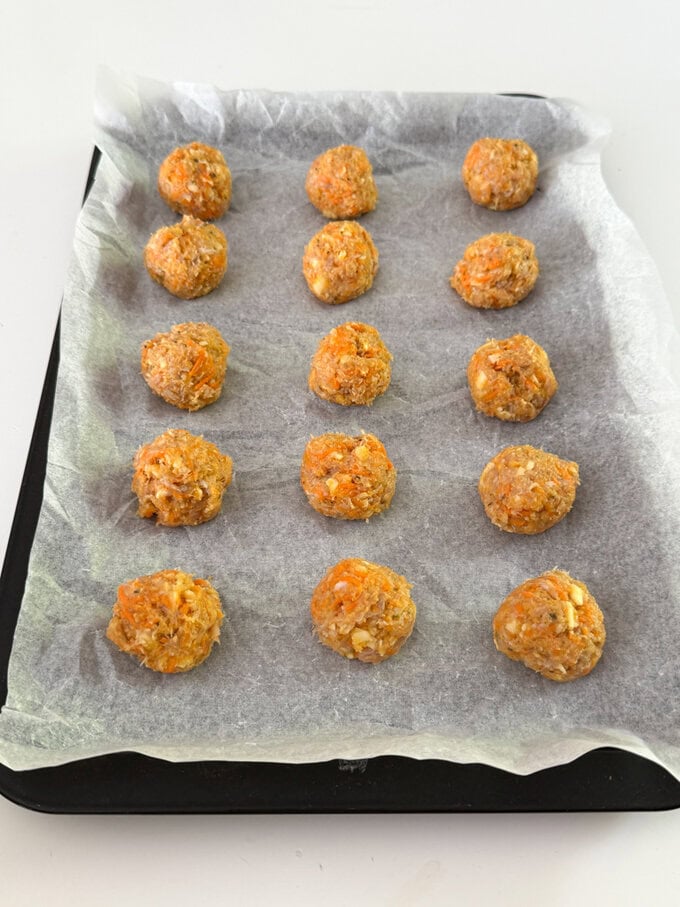 Chicken Sausage bites arranged on a baking tray ready for the oven.